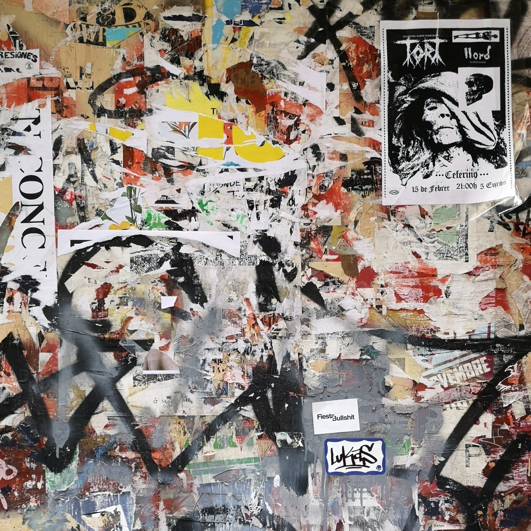 Abstract Wallpaper including black graffiti and torn paper.
