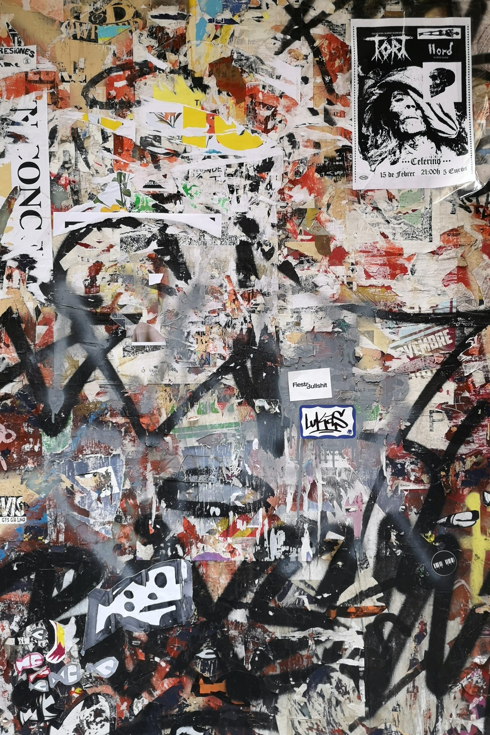 Abstract Wallpaper including black graffiti and torn paper.